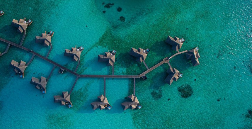 aerial shot of huts in the sea